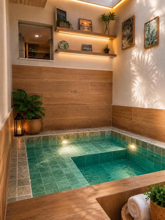 a lap pool in a house with green tiles at Flat com Jacuzzi - Cantinho do Lago 2 in Capitólio