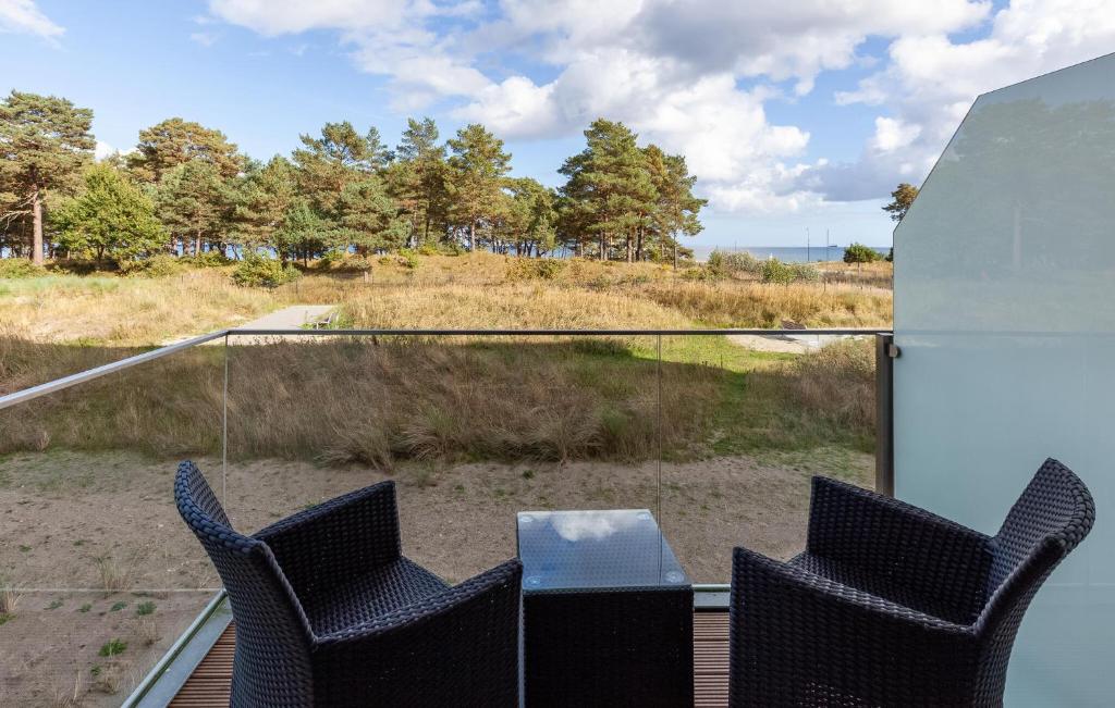 a patio with two chairs and a table on a balcony at Diamond in Binz