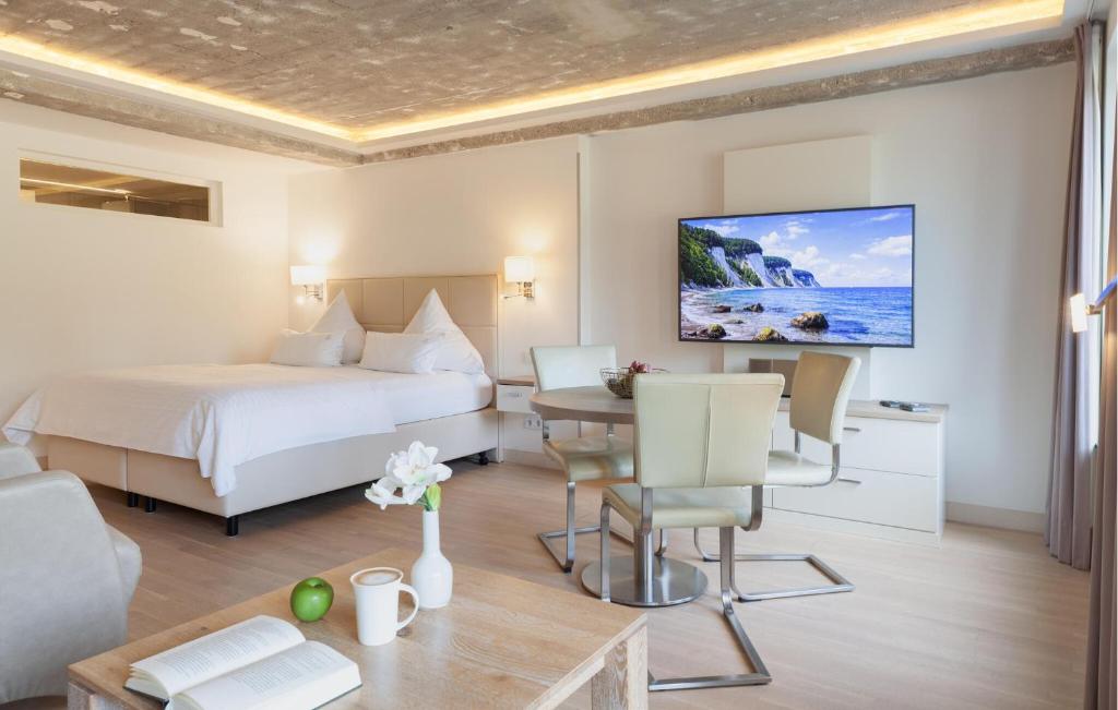 a hotel room with a bed and a table at Baltic in Binz