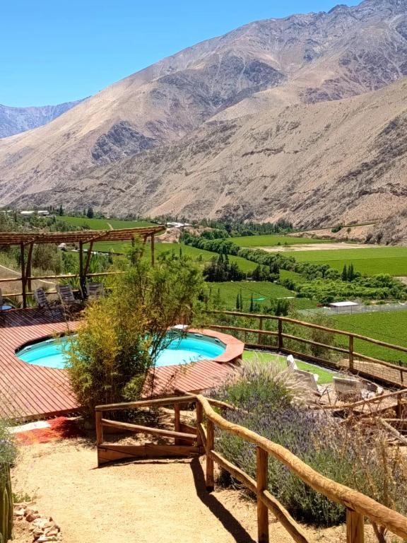 a resort with two pools and mountains in the background at Cabañas "Terrazas de Orión" con Vista Panorámica en Pisco Elqui in Pisco Elqui