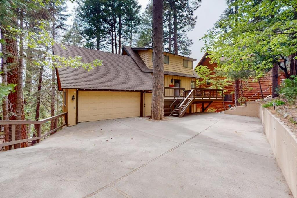 a house with a garage and a tree at Rocky Pines in Twin Peaks