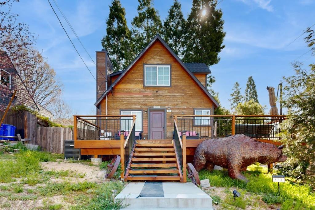a house with a bear statue in front of it at Heliotrope Hideaway in Lake Arrowhead