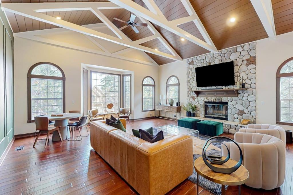 a living room with a couch and a fireplace at The Chateau in Lake Arrowhead