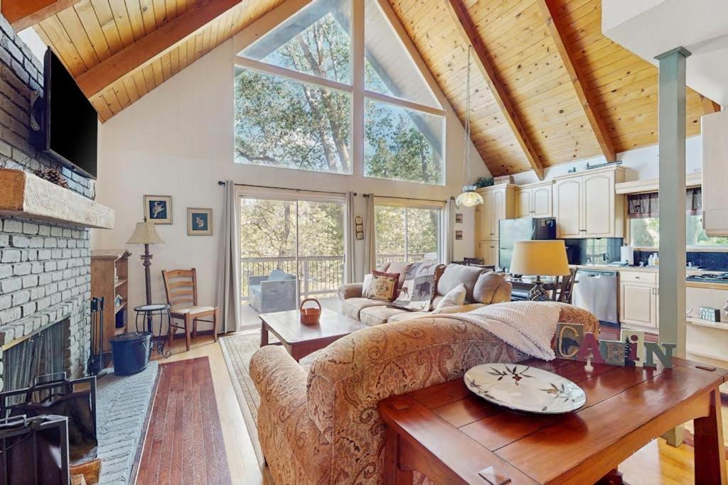 a living room with a couch and a table at Cedar Glen Hideaway in Lake Arrowhead
