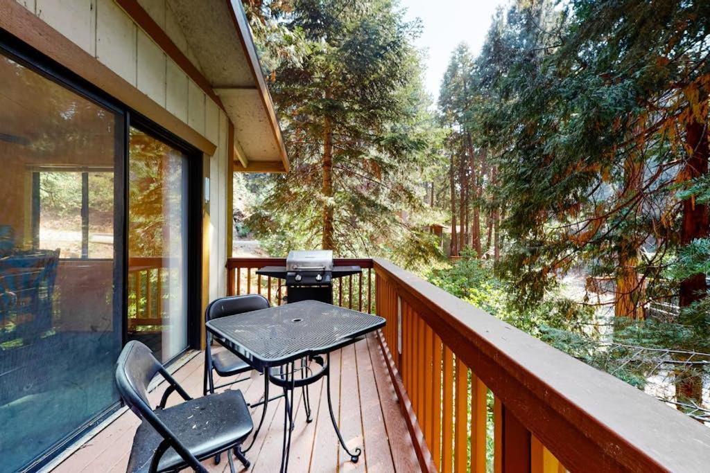 a porch with a table and chairs on a balcony at Morrison Manor in Lake Arrowhead
