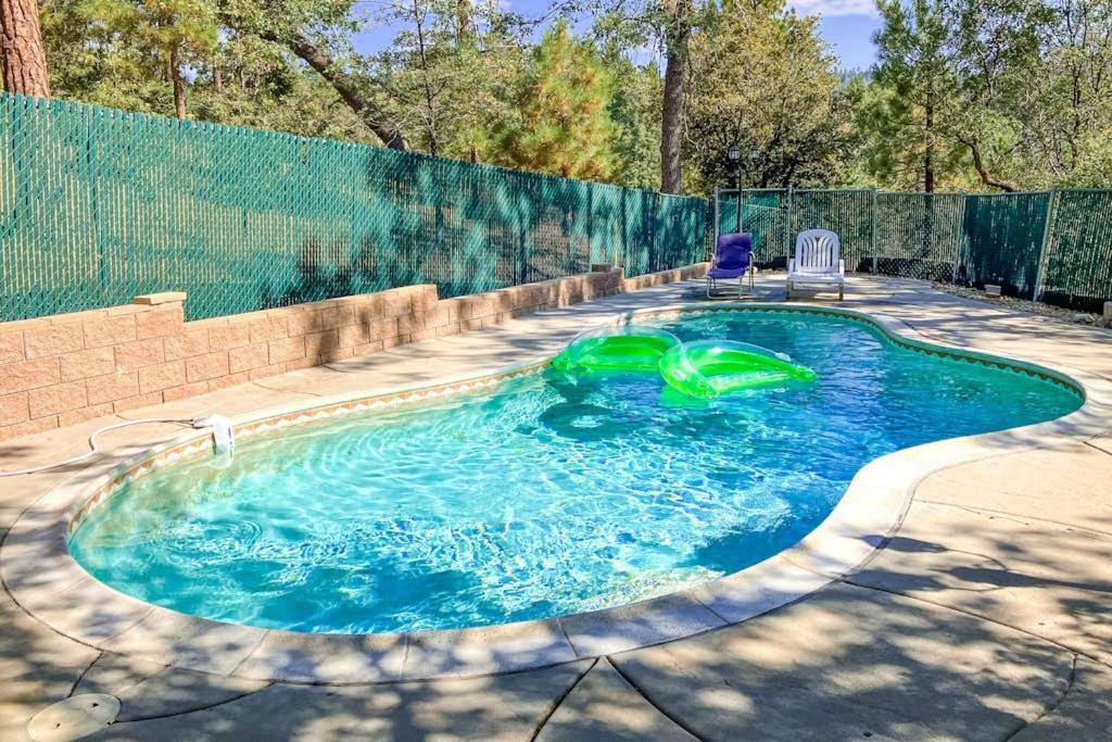 a small swimming pool with two lawn chairs in it at Running Springs R-n-R in Running Springs