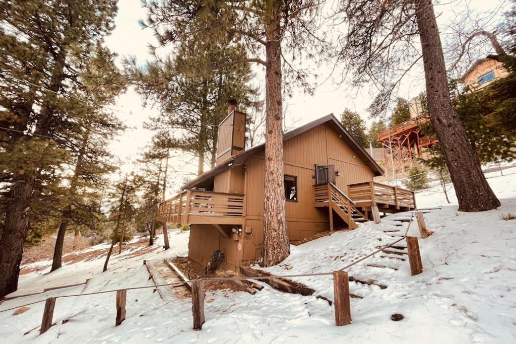 a cabin in the woods in the snow at Grey Stone Fire in Running Springs