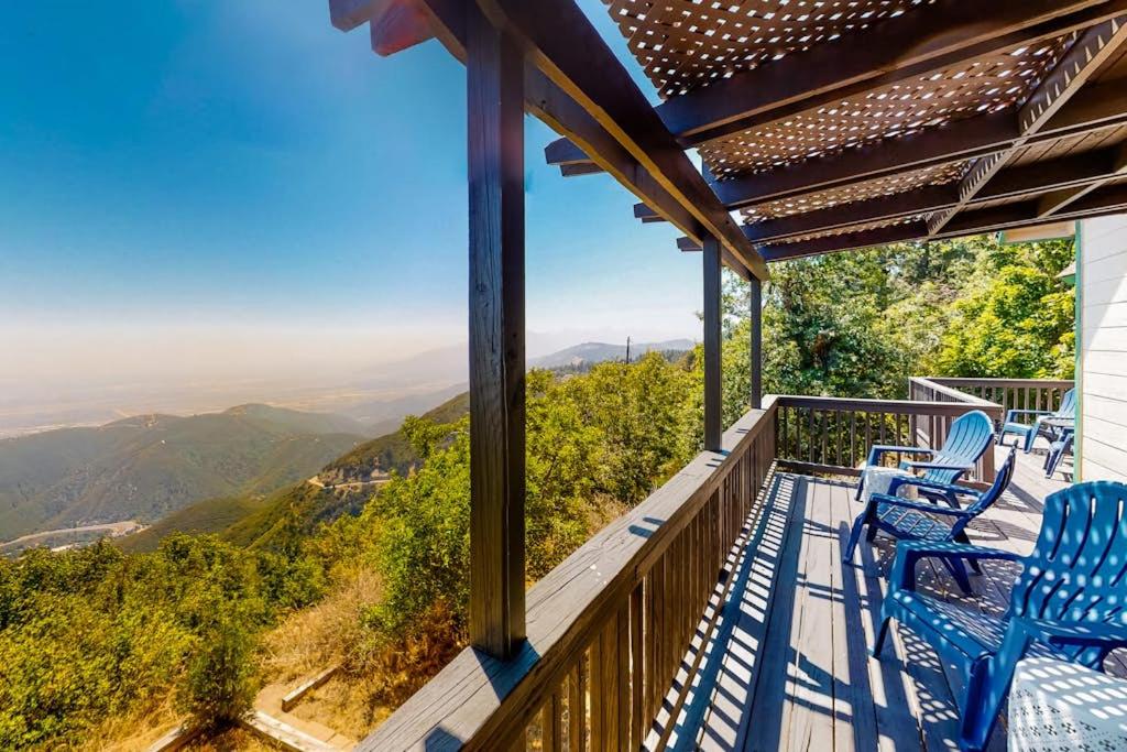 a balcony with blue chairs and a view of the mountains at Million Dollar Mountain View in Crestline