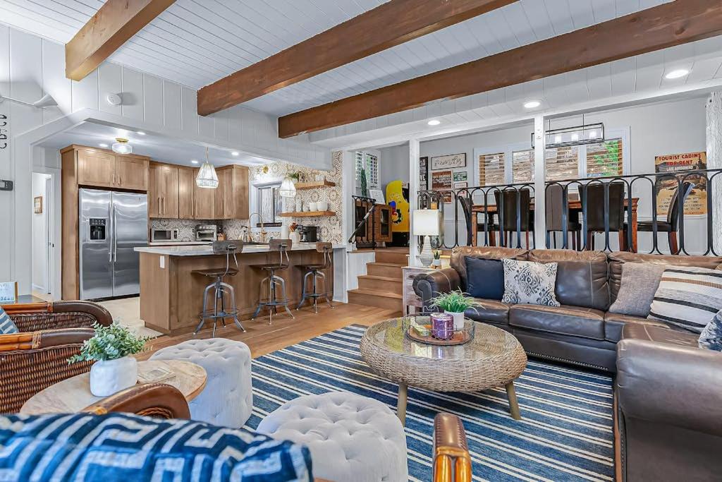 a living room with a couch and a kitchen at Serene Cabin in Lake Arrowhead