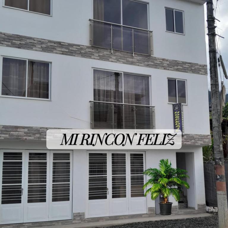 a white building with a sign that reads muncie falls at Mi Rincón Feliz in Choachí