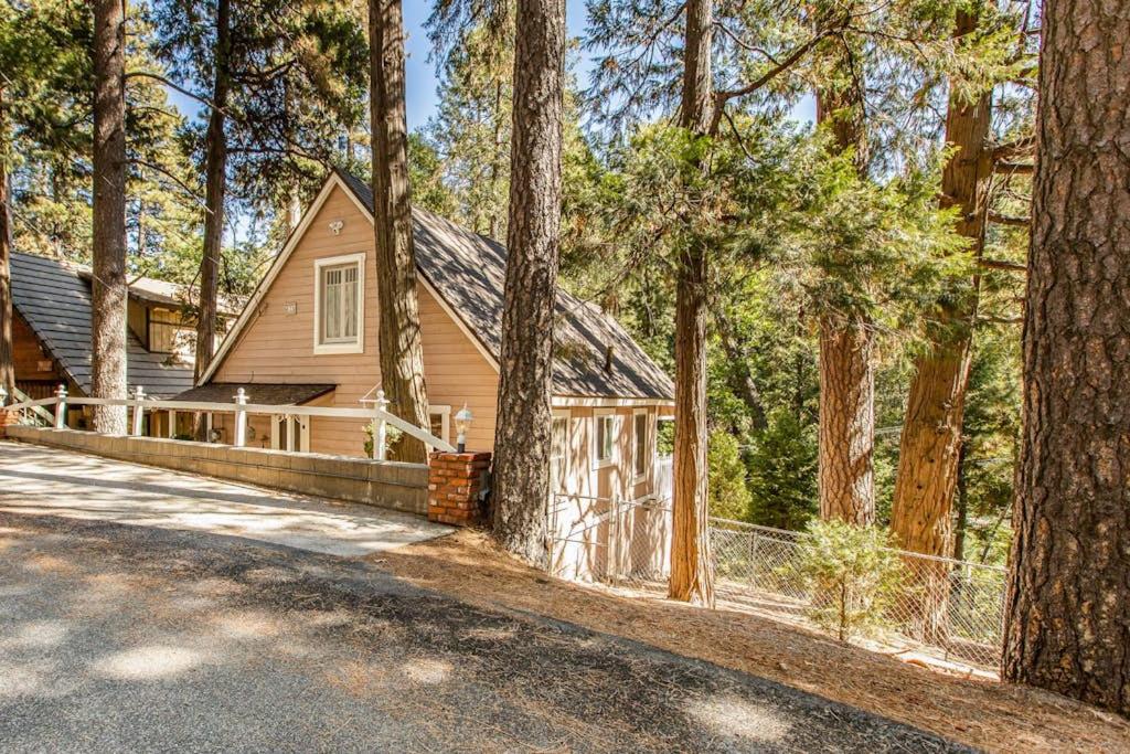 a house in the woods with a fence at The Cottage in Lake Arrowhead