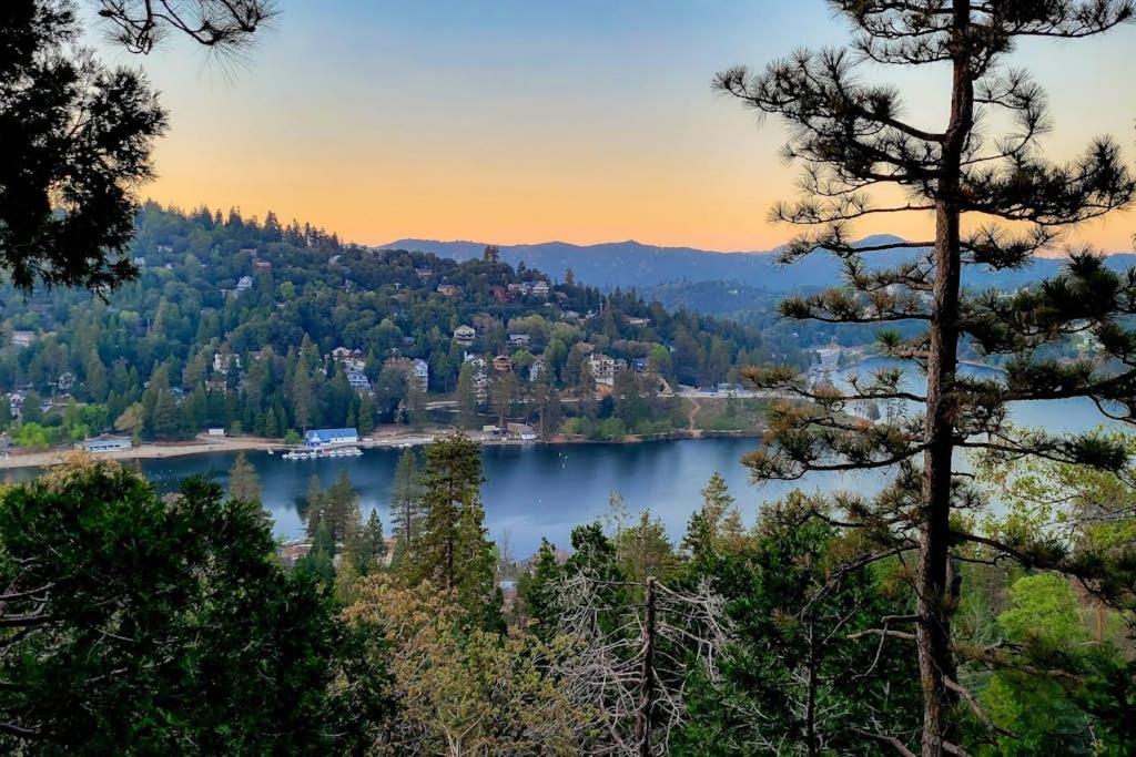 a view of a lake with trees and buildings at Lakeside Serenity in Crestline
