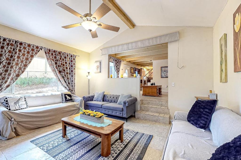 a living room with two couches and a table at Treelands Lodge in Crestline