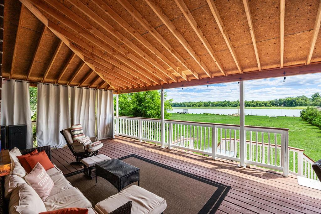 a living room with a couch and chairs on a deck at Waterfront Gem in Willingboro