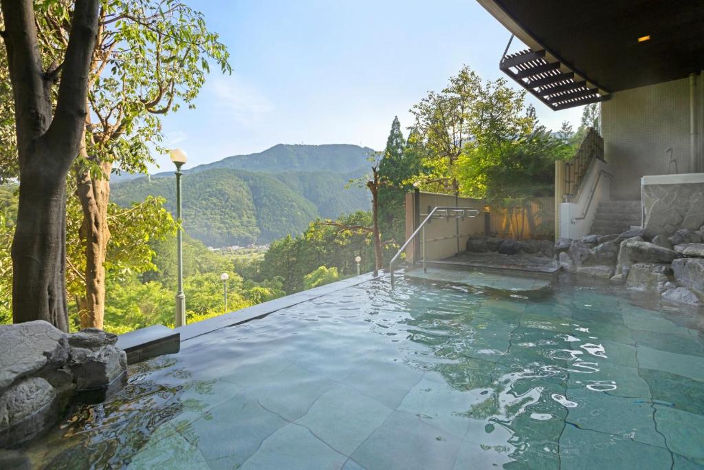 a swimming pool with a view of the mountains at TAOYA Gero in Gero