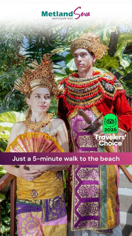 a man and woman dressed in costumes standing next to each other at Metland Seva Seminyak - Formerly Horison Ultima Seminyak in Seminyak