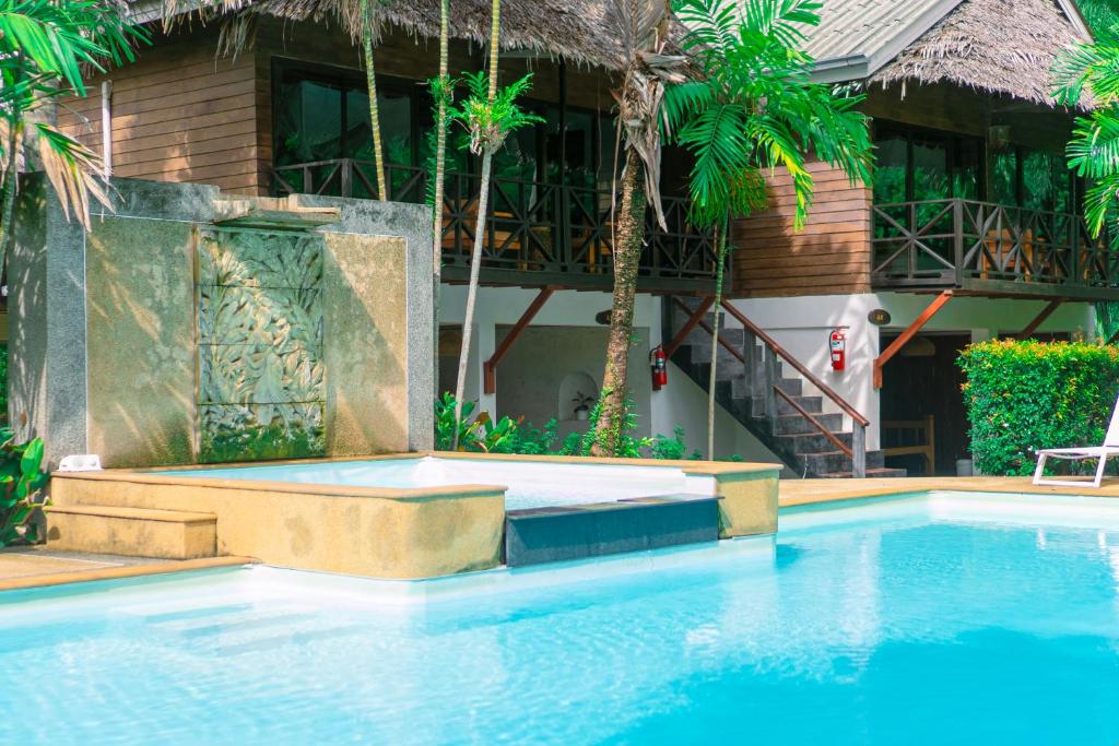 a swimming pool in front of a resort at Garden Chalets Koh Lanta in Ko Lanta