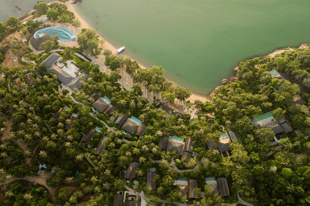 an overhead view of a forest of trees next to a beach at Villa Escape Burasari in Phuket