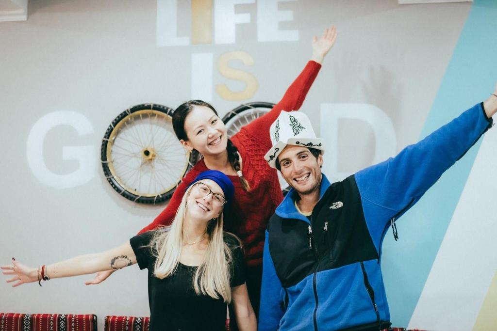 a group of people standing in front of a bike at Duet hostel in Karakol