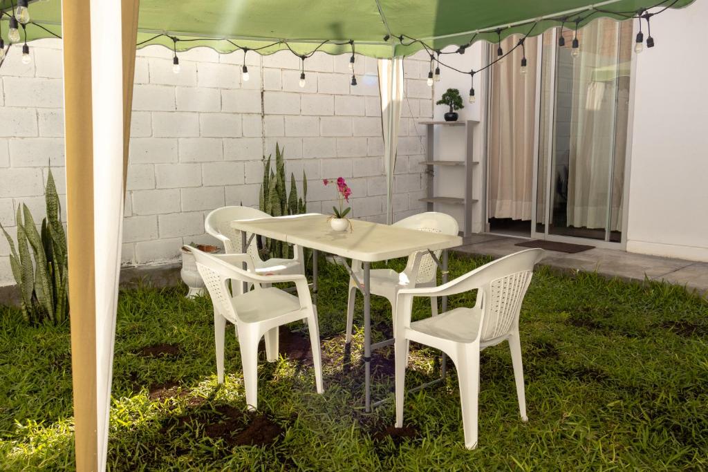 a white table and chairs under a tent at Don Checho's House in Ica