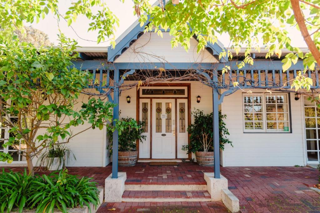 a house with a front door and trees at Lanterns Retreat in Dunsborough