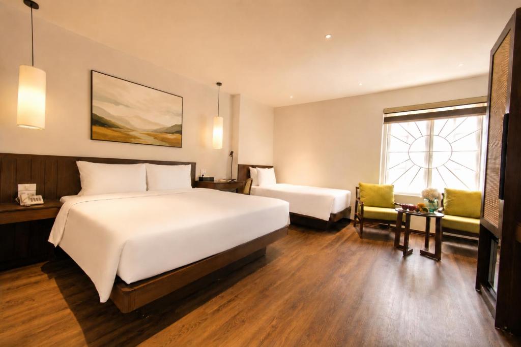 a hotel room with a large bed and a window at Pavilion Essence Hanoi Hotel in Hanoi