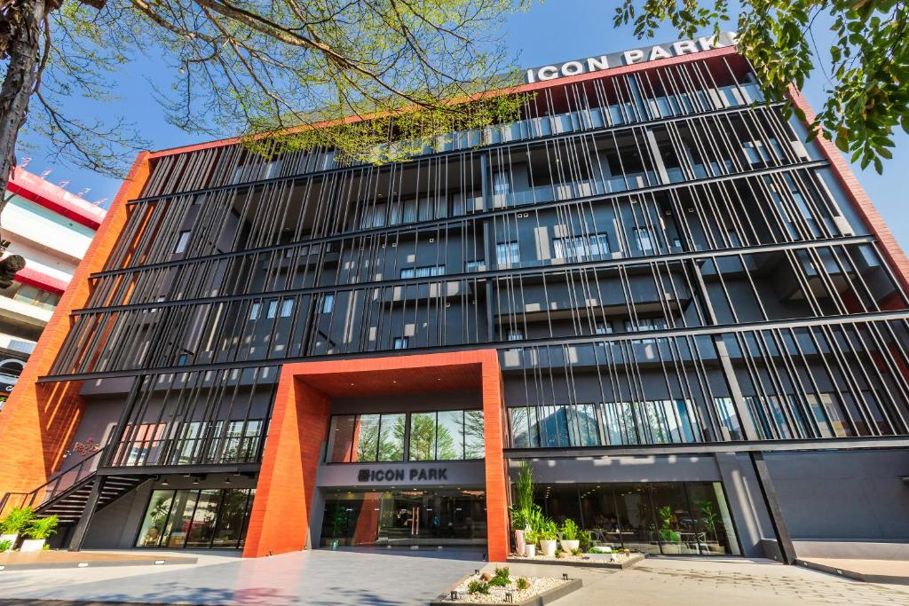 a tall building with a sign on top of it at Icon Park Hotel, Chiang Mai in Chiang Mai