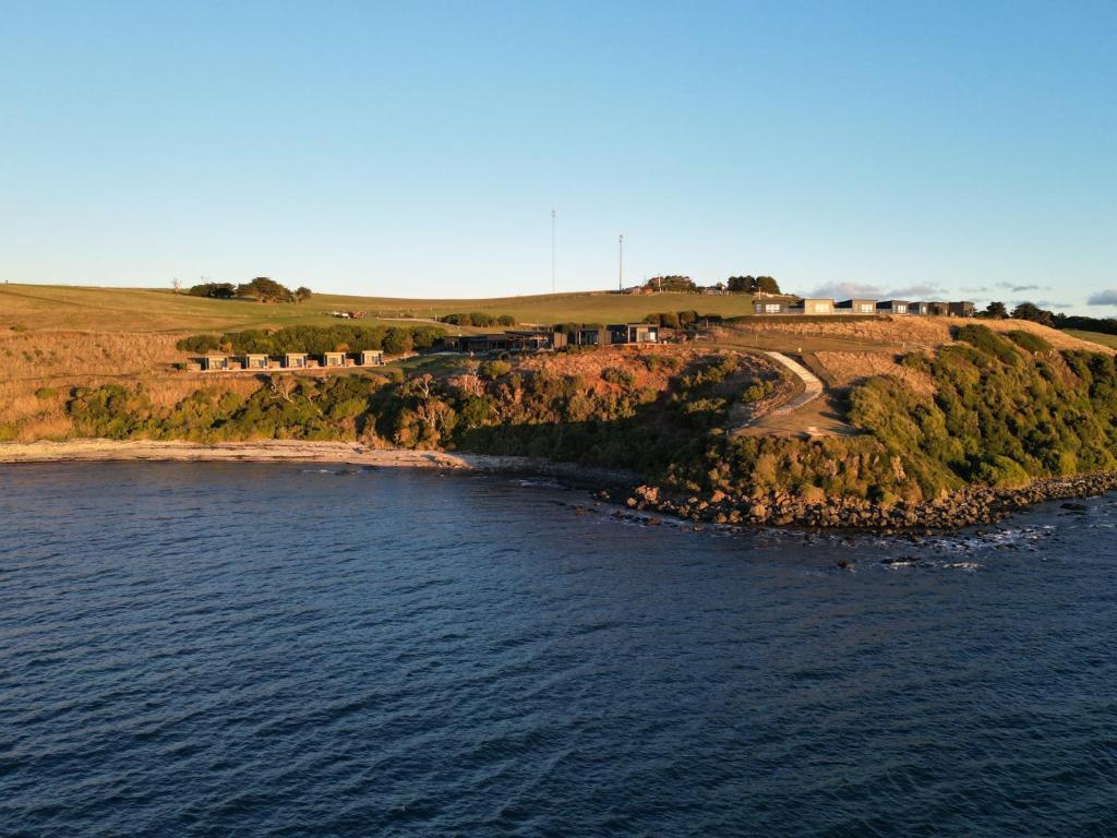 an island in the water with a train on it at The Cove Tasmania in Devonport