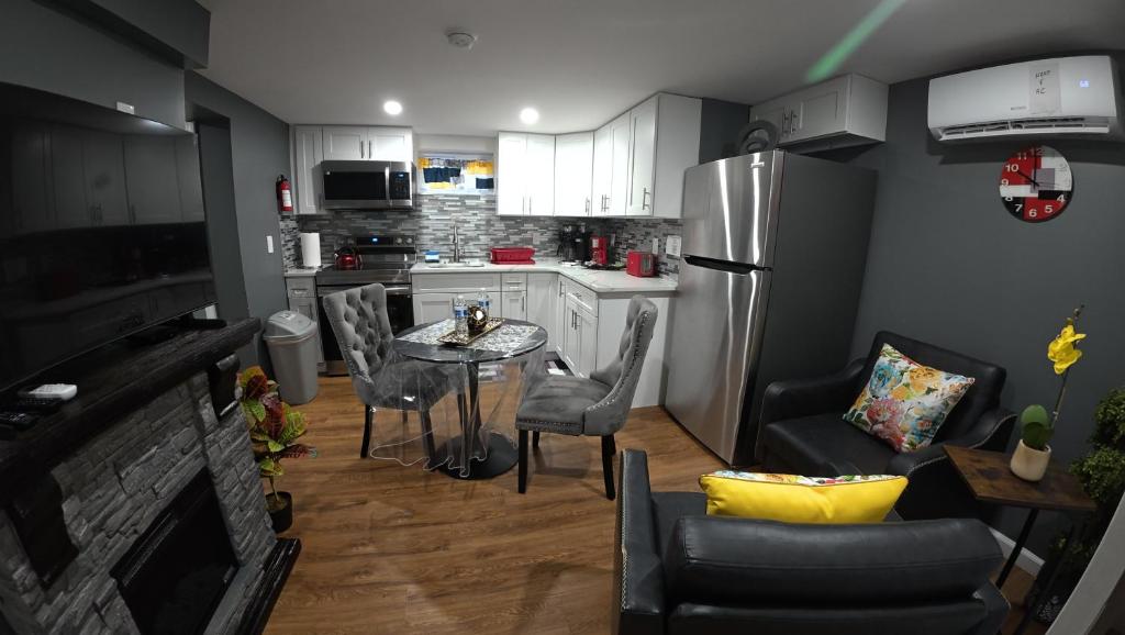 a kitchen with a table and chairs and a refrigerator at Cozy Private Two Bedroom Basement Apartment in Hempstead