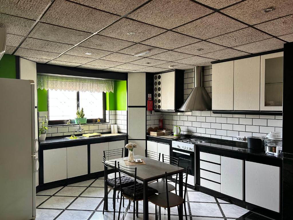 a kitchen with a table and chairs in it at Flat 3 in Mġarr