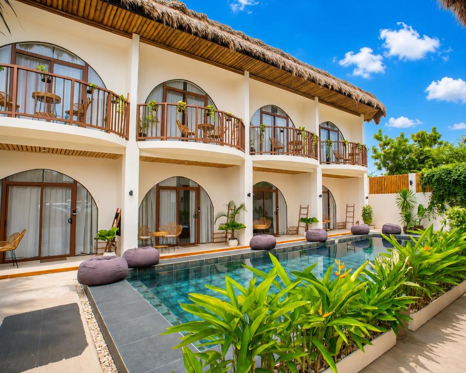 an exterior view of a villa with a swimming pool at Moana Dive Resort in Panglao Island