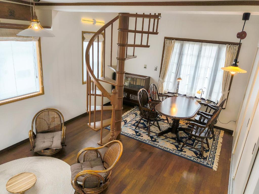 a living room with a spiral staircase and a table at Tsukui 347 B in Yokosuka