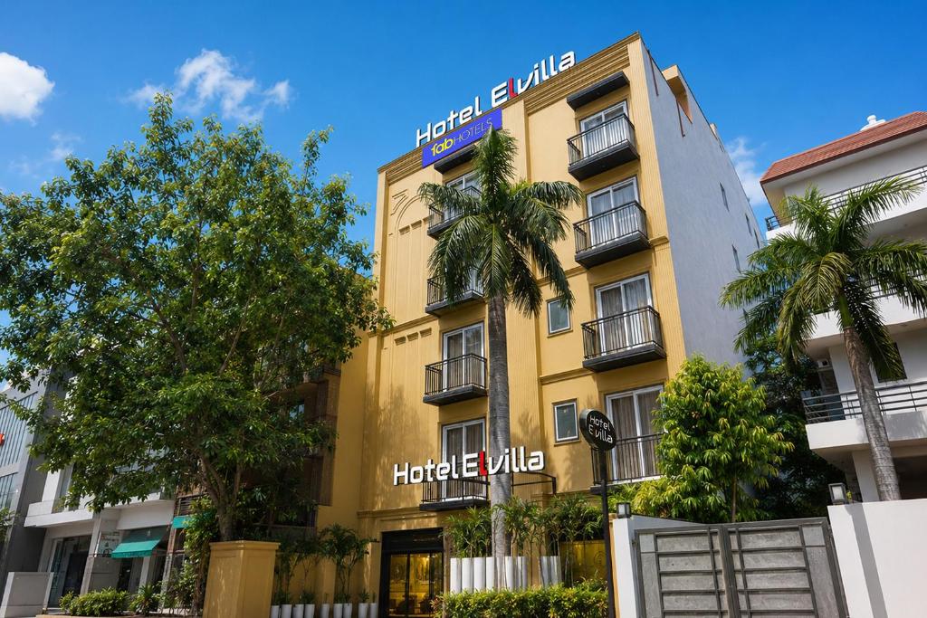 a yellow building with a sign on it at Hotel Elvilla Model Town in New Delhi