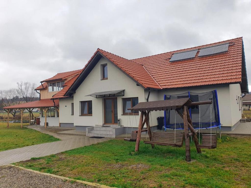 a house with a playground in front of it at Bellevue Ciucas in Vama Buzăului