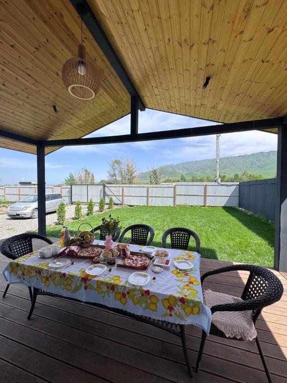 a table with food on it on a patio at Kashka-Suu house in Verkhnyaya Alaarcha