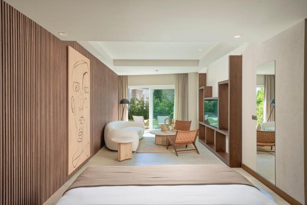 a room with a bed and a living room at Mavilu Luxury Hotel in Bodrum City