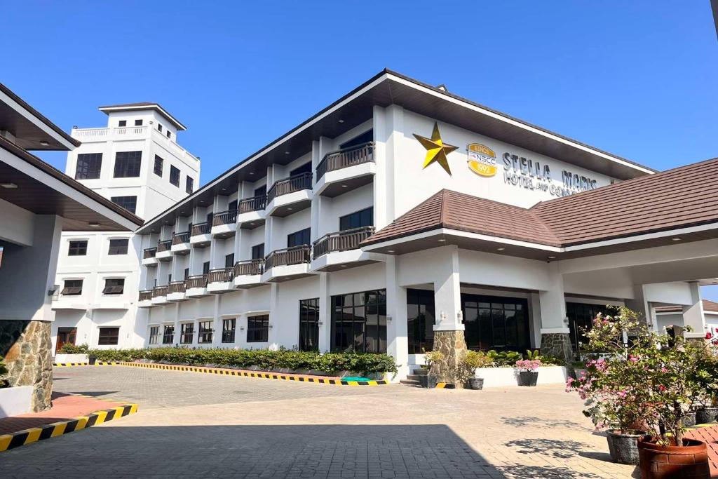 a hotel with a building with a star on it at NSCC Stella Maris Hotel & Convention Center in Cabugao