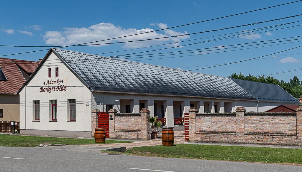 a white building with a black roof at Adamkó Borkert Ház in Villány
