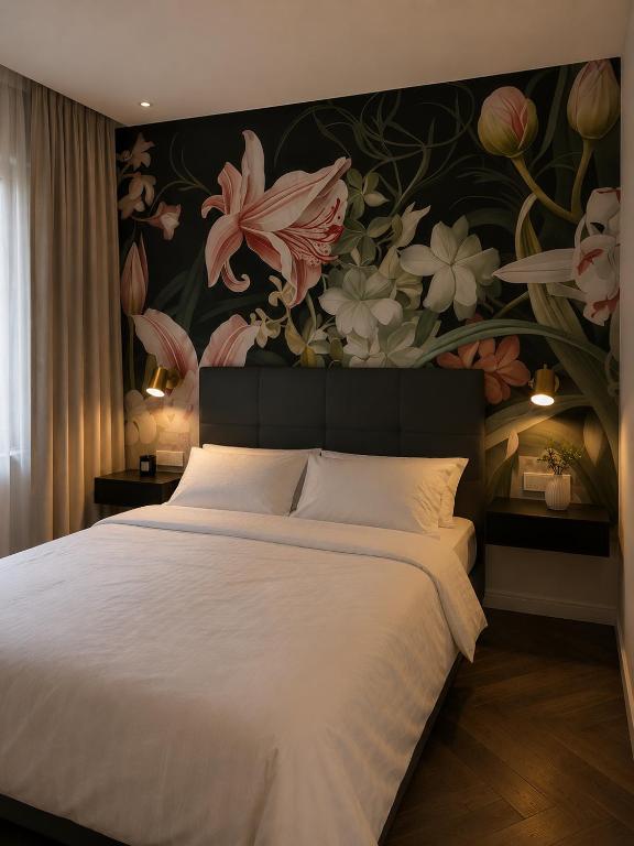 a bedroom with a large bed with a floral wallpaper at NEW TOWN Boutique Apartments & Parking in Graz