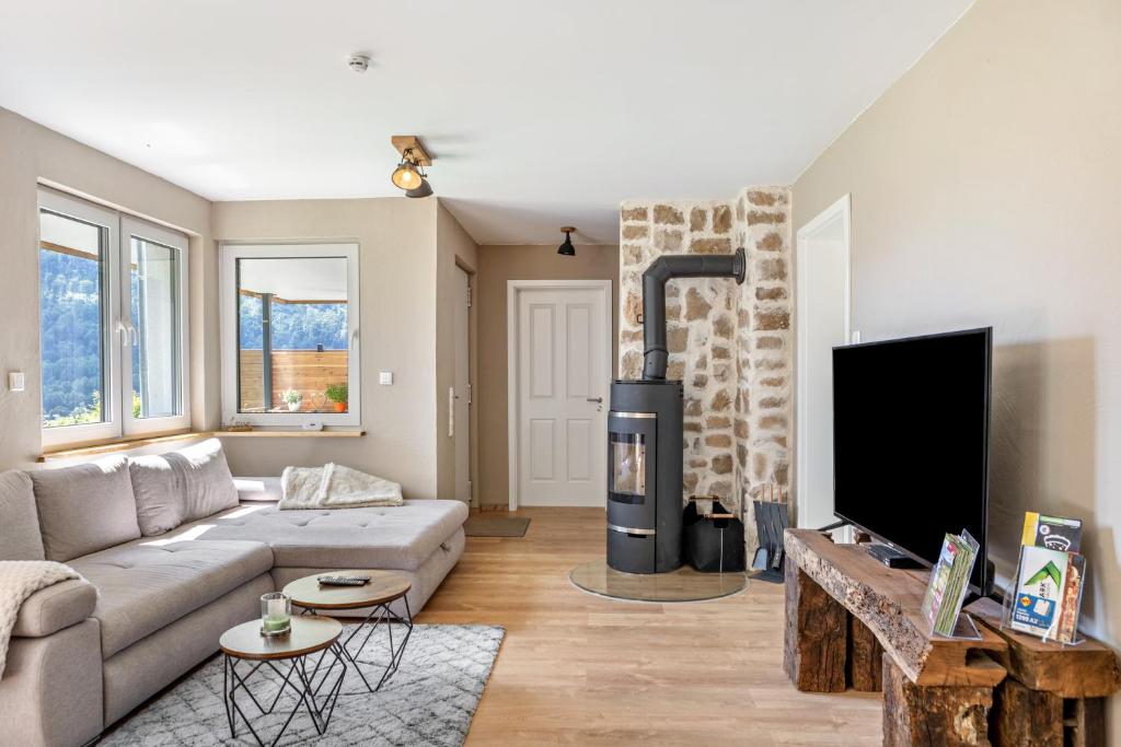 a living room with a couch and a fireplace at Auszeit Helsa in Helsa