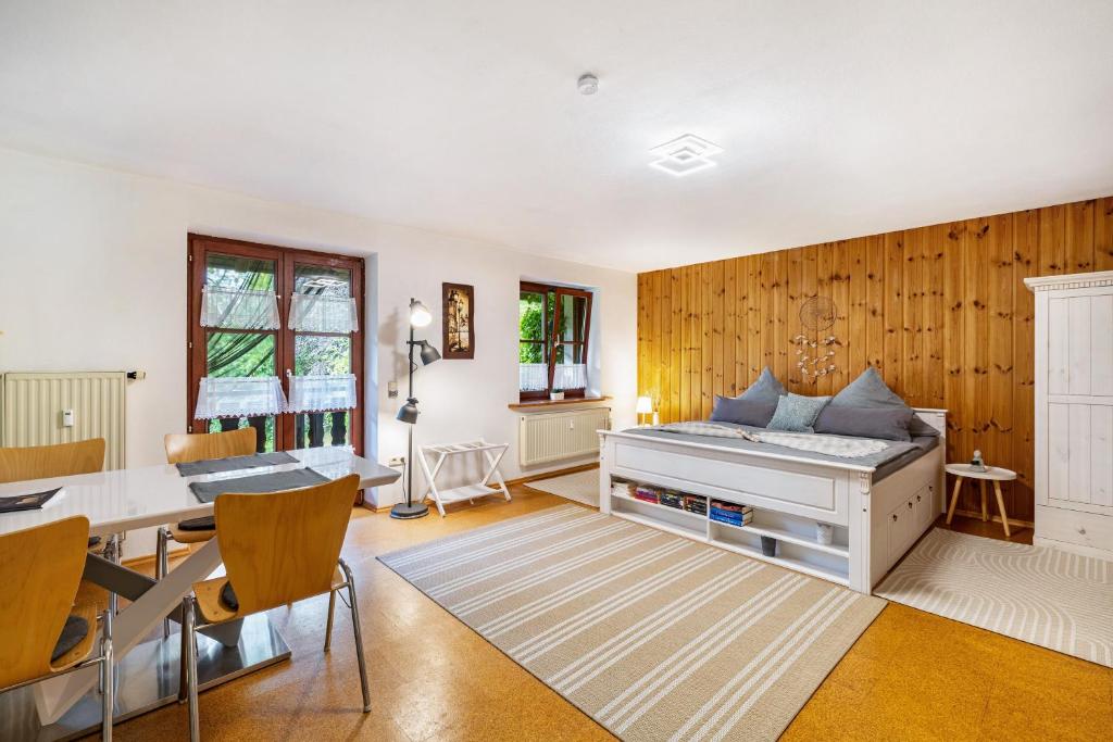a bedroom with a bed and a desk and a table at Apartment Gardenview in Kinsau