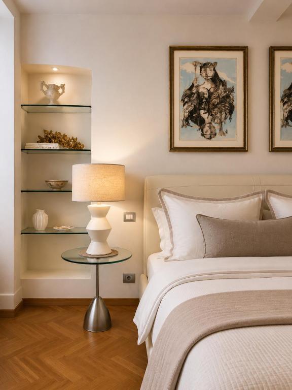 a bedroom with a bed and a table with a lamp at ComeCasa No ZTL Alfieri Urban Stay in Asti