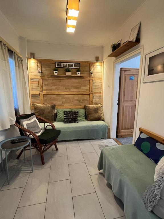 a living room with two beds and a couch at Amur Vendégház in Gárdony
