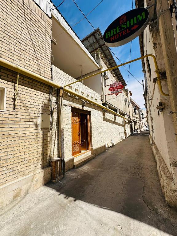 an empty street in front of a building at Mashhur in Bukhara