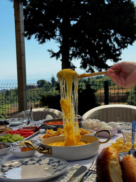 a table with a bowl of food on it at Natural Villas Trabzon in Komera
