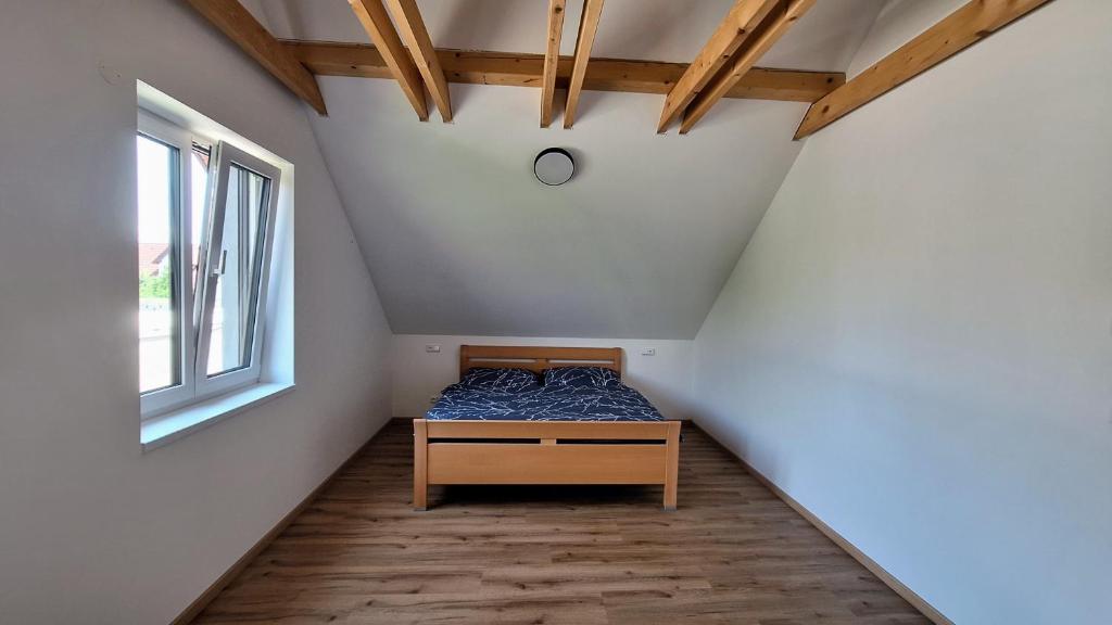a small bedroom with a bed in a attic at Thomas home in Homole