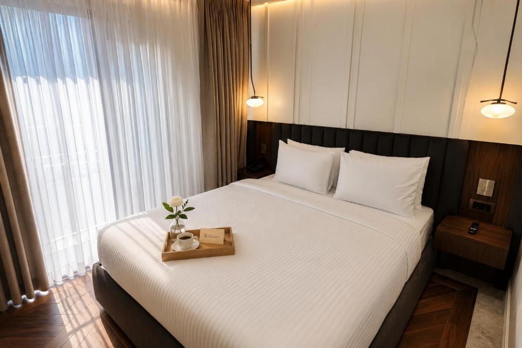 a bedroom with a large bed with a tray of flowers on it at Alaturka Mansion in Istanbul