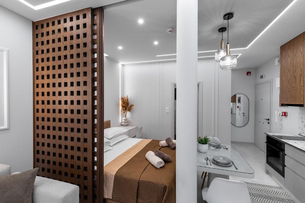 a small bedroom with a bed and a kitchen at Elite Suite in Xanthi