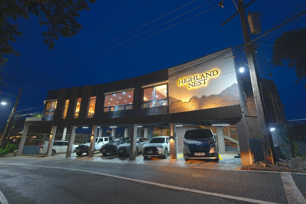 a dealership with cars parked in a parking lot at night at Highland Nest in Baguio
