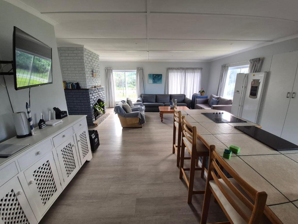 a kitchen and living room with a table and chairs at Silver’s Rest Beach House in Clareport